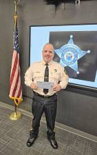 Sussex County Sheriff Michael Strada holds a blue envelope, designed to help law enforcement in recognizing and assisting people with Autism Spectrum Disorder. (Photo provided)