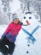 <b>SN1 Jackie Gunther, 9, with a snowman Friday, Nov. 22 in Wantage. (Photo courtesy of Rebecca Gunther)</b>