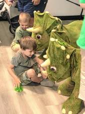 <b>Boys play with Triceratops twins during a program to kick off summer reading Saturday, June 29 at the Sussex-Wantage branch of the Sussex County Library System. (Photos by Kathy Shwiff)</b>