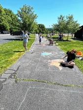 Leanna Mentone, 19, works on her drawing during the seventh annual Sidewalk Chalk Art Festival on Saturday, June 1 in Vernon. (Photos by Daniele Sciuto)