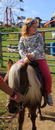 Hannah Peterson of Sparta took time for a pony ride at the Pumpkin Festival.