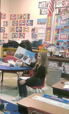 A fifth-grader from Lounsberry Hollow School in Vernon reads a holiday story to younger students.