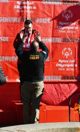 William Trainello of Washington, N.J., is congratulated after receiving a medal.