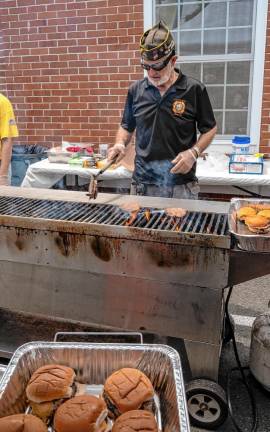 Rudy Beckmann prepares burgers at the lunch hosted by Veterans of Foreign Wars Post #7248 in Sparta. (Photo by Nancy Madacsi)