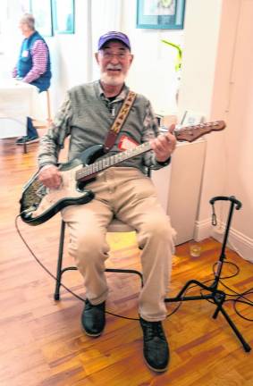 Dave Fisher entertains at the exhibit’s opening reception Saturday, Feb. 24 in Newton.