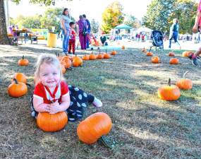 <b>Addison Smith poses in the pumpkin patch at the Fall Fest on Saturday, Oct. 19 in Ogdensburg. (Photo by Maria Kovic)</b>