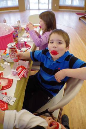 Nicholas Ferreri, 8, proves that cupcake construction is all in the lips.