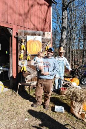 <b>Rich Ziccardi of Wantage holds his baby, Reagan, by the barn.</b>