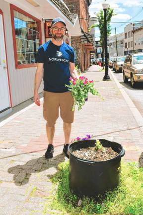 Sean Hyland, Norwescap’s community development project manager, helps with the cleanup.