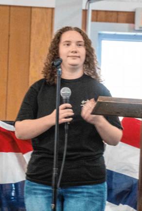 <b>Emma Cooper sings the National Anthem.</b>