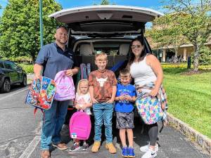The Saporito family donates backpacks to Project Self-Sufficiency. (Photo provided)