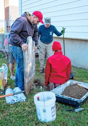 RW1 Nick Franko, Xavier Franko and Pete Dresso repair a headstone in the graveyard behind the Sparta Presbyterian Church. Nick Franko is the scoutmaster of Troop 95 and Xavier Franko is the assistant senior patrol leader. (Photos by Nancy Madacsi)