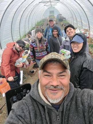 Michaeline Mann (in colorful fleece) and Vincent Mann (front), Turtle Clan Chief of the Ramapough Lenape Nation, at their farm in Newton, NJ. They have been getting a lot of calls, because they are on the short list of historically underserved farms. Photo by Michael Mann