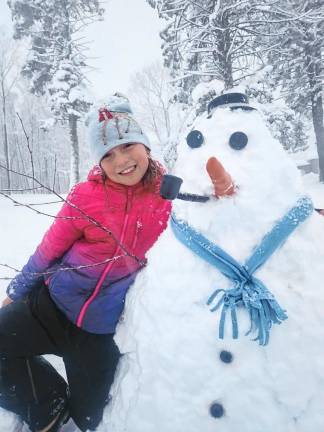 <b>Jackie Gunther, 9, with a snowman Friday, Nov. 22 in Wantage. (Photo courtesy of Rebecca Gunther)</b>