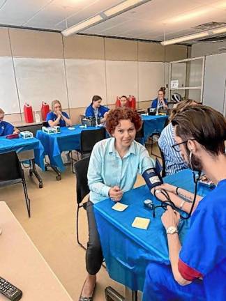 Students in the Medical Assistant program practice their medical training during the Health Fair. (Photo provided)