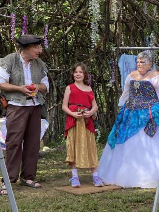 A girl stands next to the Fairy Jugglers.