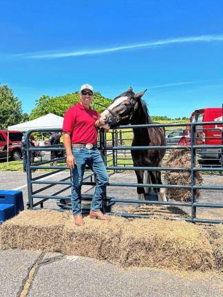 Marcus Luce, a candidate for the Wantage Township Committee, with a horse from his farm. (Photo by Daniele Sciuto)