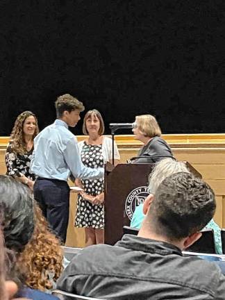 <b>Jack Schmick receives a scholarship from Lisa Murphy, Valerie Seufert and Anne Whitty.</b>