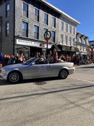 Jolisse Gray waves to the crowd during the holiday parade in December in Newton. (Photo provided)