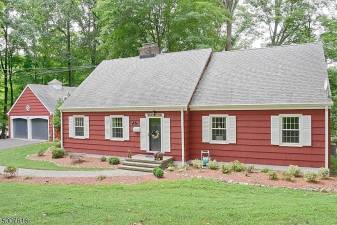 Four-bedroom colonial is nestled in a parklike setting