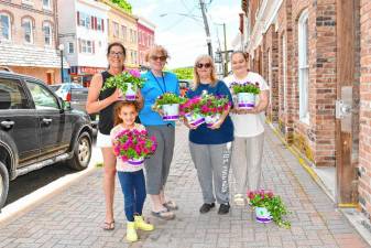 From left are Kathy Esposito and her granddaughter Maya, Dianna Morrison, Kari Trudeau and Kristin Kasperowicz. They are cleaning up and planting flowers along Main Street in Sussex on Friday, May 31. Morrison is director of Pathways 2 Prosperity, a collaboration between Norwescap and United Way of Northern New Jersey. (Photos by Maria Kovic)