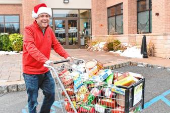 Steve Allan of radio station 102.3 WSUS brings donated food to a Sussex County Skylands Ride bus Friday, Nov. 22 at the Provident Bank in Sparta. (Photos by Maria Kovic)