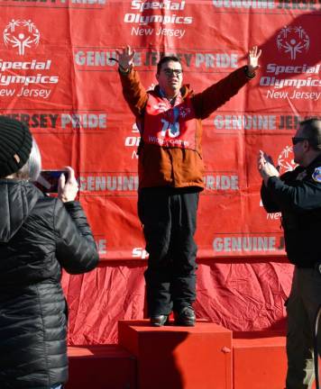 William Trainello of Washington, N.J., stands on the podium at the Special Olympics.