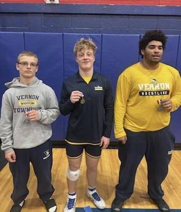 The Vernon Township High School boys wrestling team competes in the Lenape Valley Holiday Tournament on Dec. 18. Gavin Pych, center, wins first place, and Mike Ivancich, left, and Zyon Taylor both place second in their weight classes. (Photo provided)