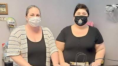 Sisters Lisa Russinko (left) and Heather Russinko stand behind their custom-made sales counter at their new confectionery supply shop, Sugar Sisters, located on Main Street in Franklin (Photo by Mandy Coriston)