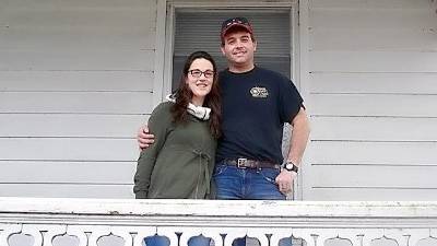 Kristen and Jason Touw happily pose on the porch of the “big house” located on Wagon Wheel Farm, Sarah Wells Trail, in Goshen. After long negotiations with inheritors of the property, the Touw offer to purchase was finally accepted.