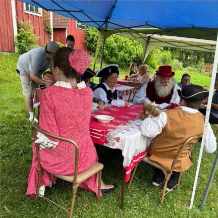 DR1 John Bradford, dressed as Santa Claus, talks to children at the Christmas in July open house Sunday, July 16. (Photos by Daniele Sciuto)