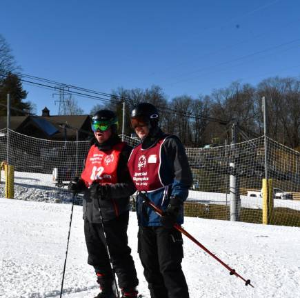 Robert Hopkins, left, of Edison waits to compete in Alpine skiing.