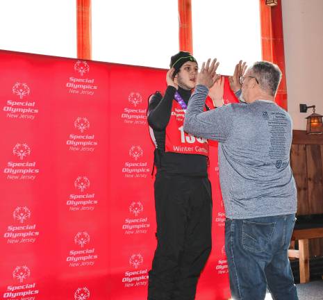 <b>Keegan McNulty receives a</b> medal in Novice Slalom Skiing. (Photo by Maria Kovic)