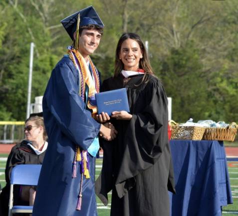 Principal Lindsay Leduc-Young hands a diploma to Michael Evanick. (Photo by Theresa Sabia)