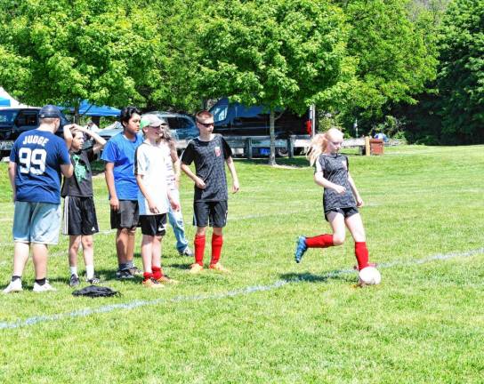 Children play kickball. (Photo by Maria Kovic)