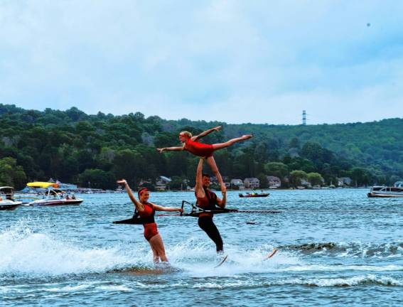 Kate Sutphen, left, is on her swivel ski as Carter Higgins performs a straps lift with Saige Lieb during the Ski Hawks’ first show of the season on Memorial Day on Lake Mohawk in Sparta. (Photo by Maria Kovic)