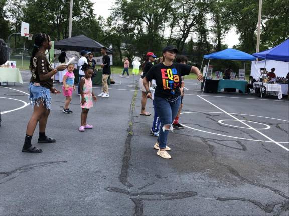 Members of the crowd dance at the Juneteenth celebration.