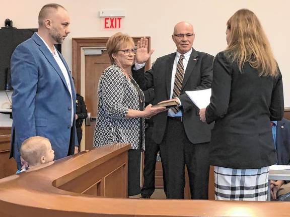 Former Lafayette Mayor Alan Henderson takes the oath of office as a member of the Sussex County Board of County Commissioners on Wednesday, Jan. 1. From left are his son, Andrew; his wife, Lorie; and his daughter, Vanessa Henderson-Aikens, who administered the oath. (Photo by Kathy Shwiff)