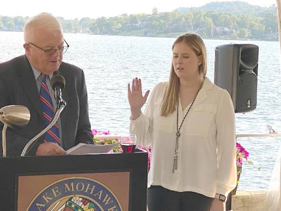 Newly elected SCBA President Kelly Sherwood recites her oath, administered by the Honorable William J. McGovern, III.