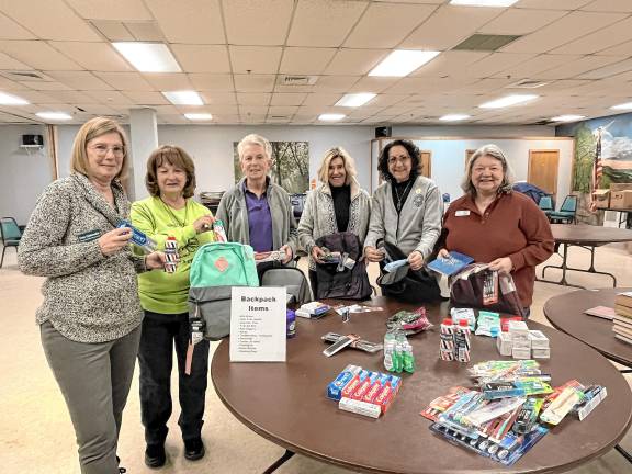 <b>Volunteers packing backpacks are Fran Gialanella, Vernon Township Woman’s Club co-president; club member Karen Szepietowski; Phyllis Chanda, Roxbury Woman’s Club president; Karen Jeisi, Highlands District vice president; Barbara McCloskey, president, New Jersey State Federation of Woman’s Clubs; and Nancy Levy. corresponding secretary, NJSFWC.</b>