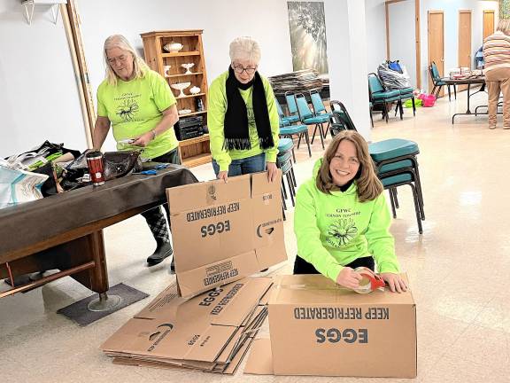 <b>Vernon Township Woman’s Club members Elaine Hossfield, Day of Service chairwoman; Karen Breese; and Lisa Mills construct boxes for shipping. (Photos provided)</b>