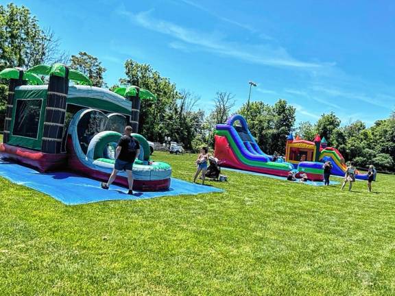 Children’s activities include bounce houses and inflatable slides. (Photo by Daniele Sciuto)