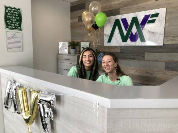 CA2 Amanda Viglione, left, and Melissa Jung work the front desk of Mountain View Farmacy. The cannabis retailer held its grand opening Sunday, July 30.