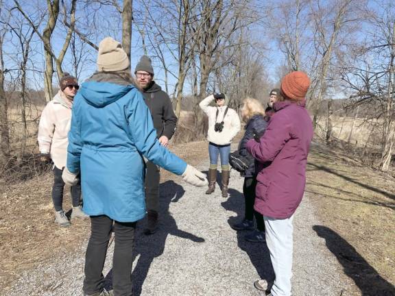 Giselle Smisko, facing away, talks to bird counters. She is president of Friends of the Wallkill River National Wildlife Refuge.