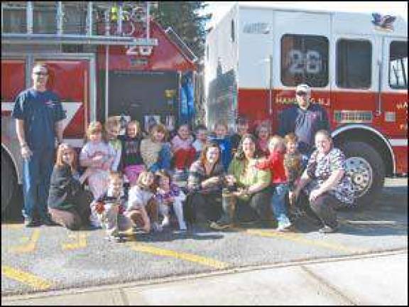 Firefighters donate to school fundraiser