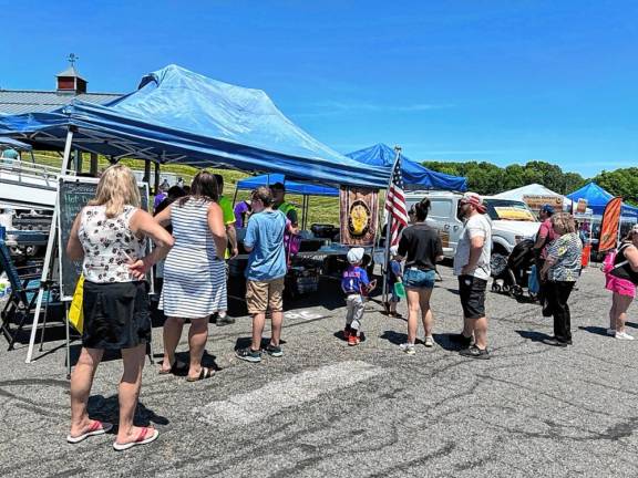 People wait in line at the Sussex Elks Post #2288 table, where they were selling hot dogs, hamburgers, cheesesteaks, and sausage and peppers. (Photo by Daniele Sciuto)