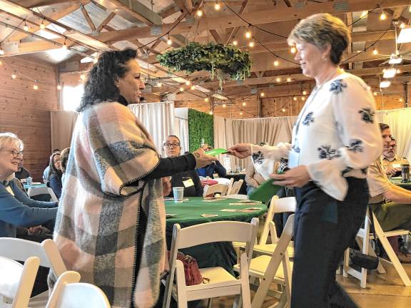 <b>Susan Foy, right, vice president</b> of the German Christmas Market of New Jersey, presents a check to Valerie Macchio, executive director of the Sparta Community Food Pantry.