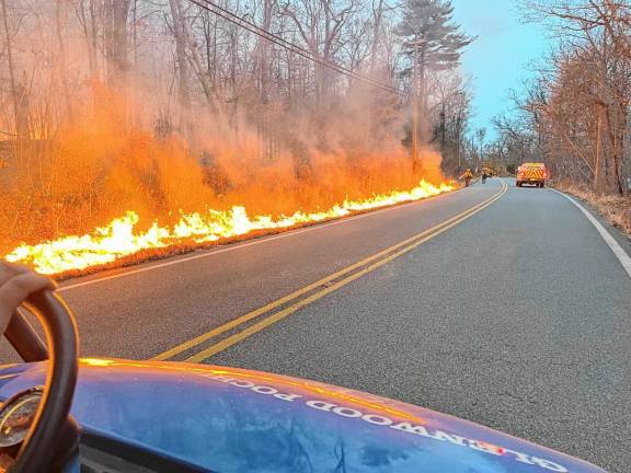 Members of the Vernon Emergency Medical Services Special Operations Division drive past flames in West Milford. (Photo provided)