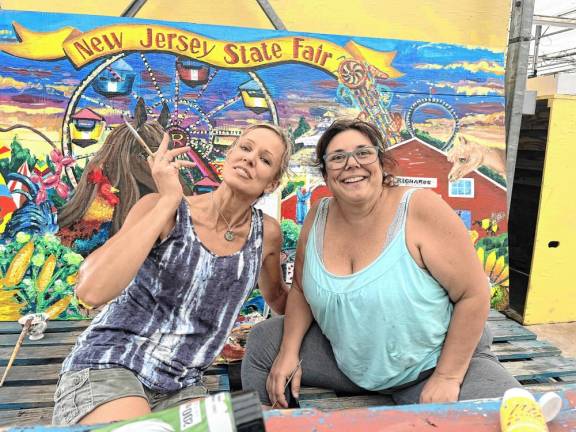 <b>Erin Meyers, left, and Lisa Hodgins in front of the new mural. They taught art together at High Point before Hodgins retired.</b>