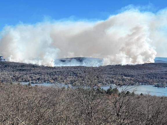 Smoke rises from wildfires on the eastern side of Greenwood Lake. (Photo by Douglas Miller)